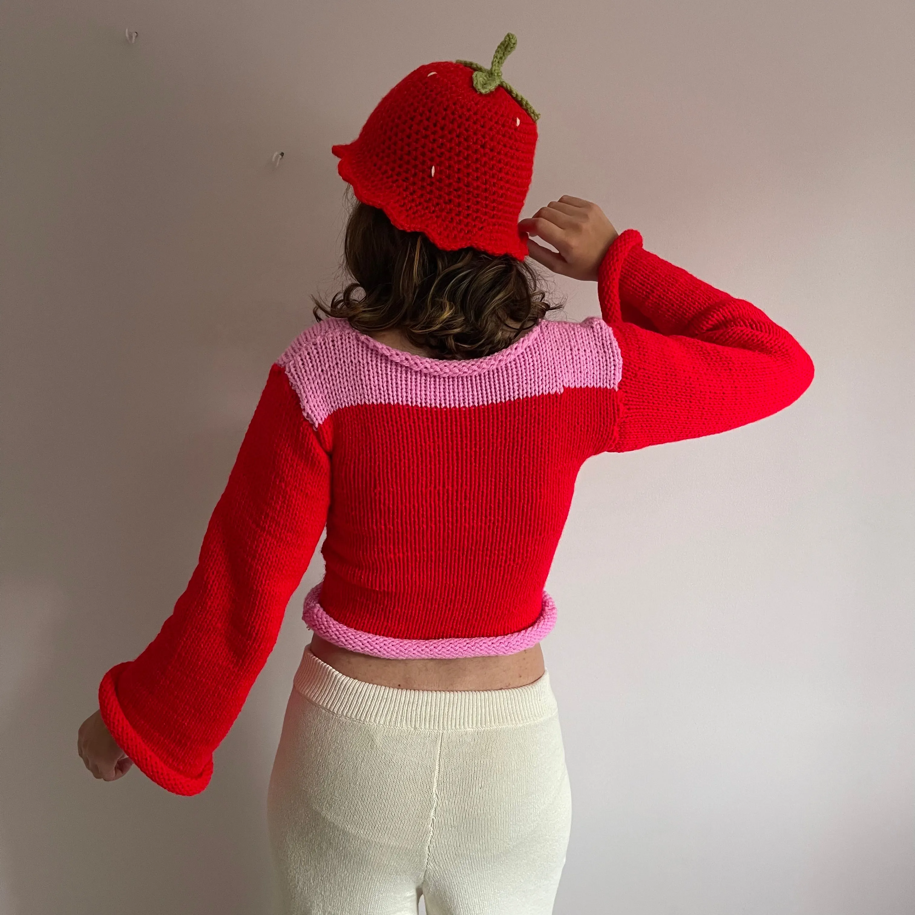 Handmade knitted colour block jumper in red and pink