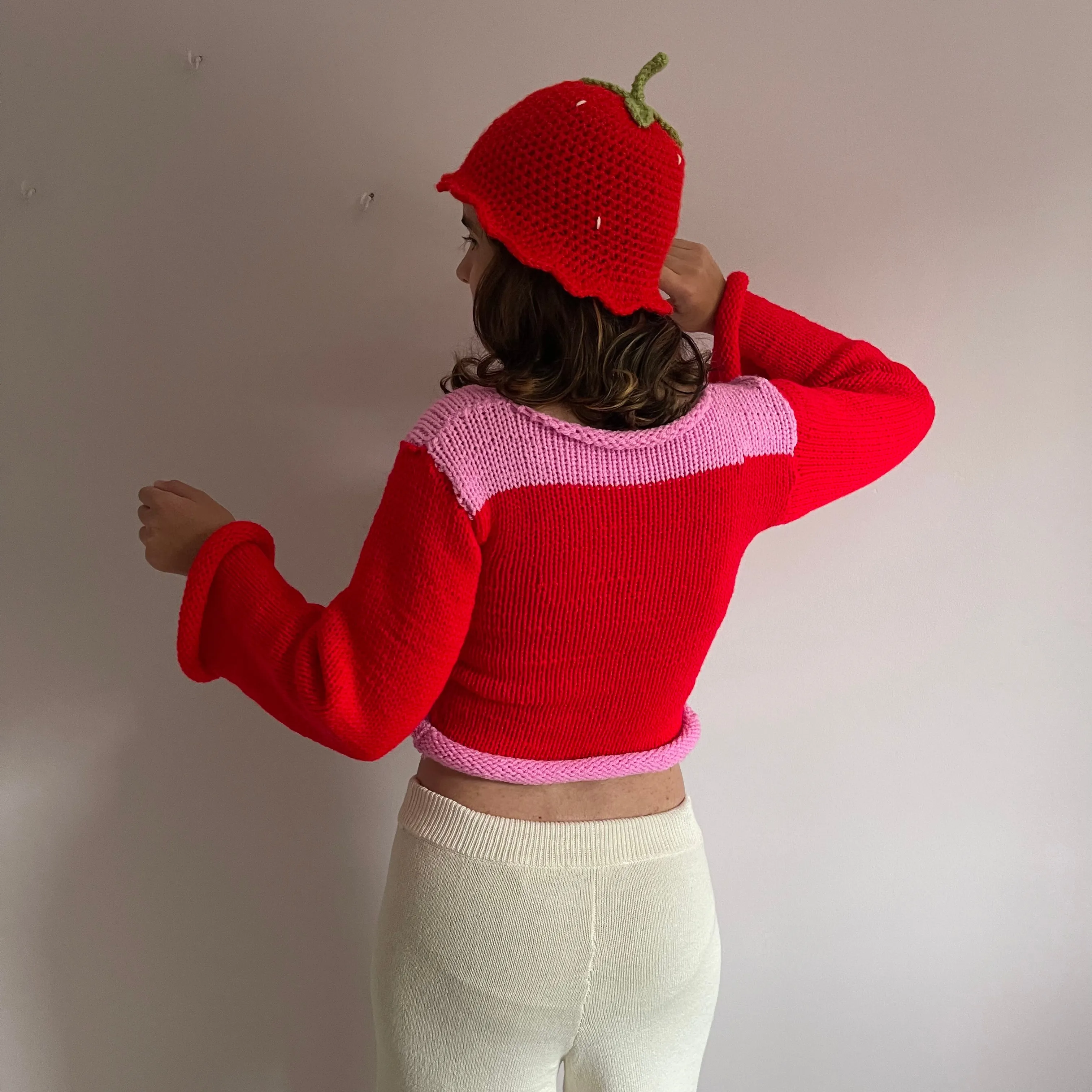 Handmade knitted colour block jumper in red and pink