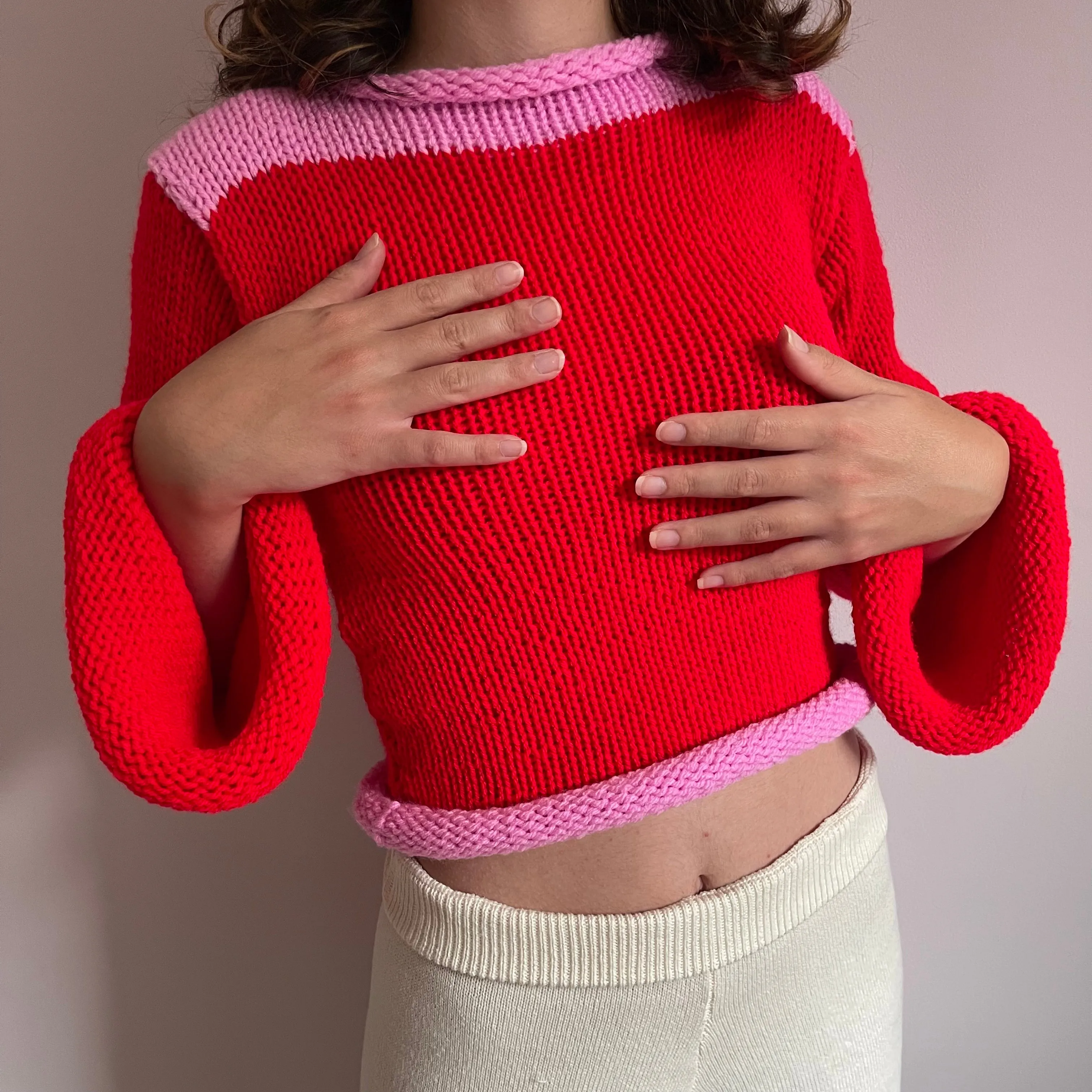 Handmade knitted colour block jumper in red and pink