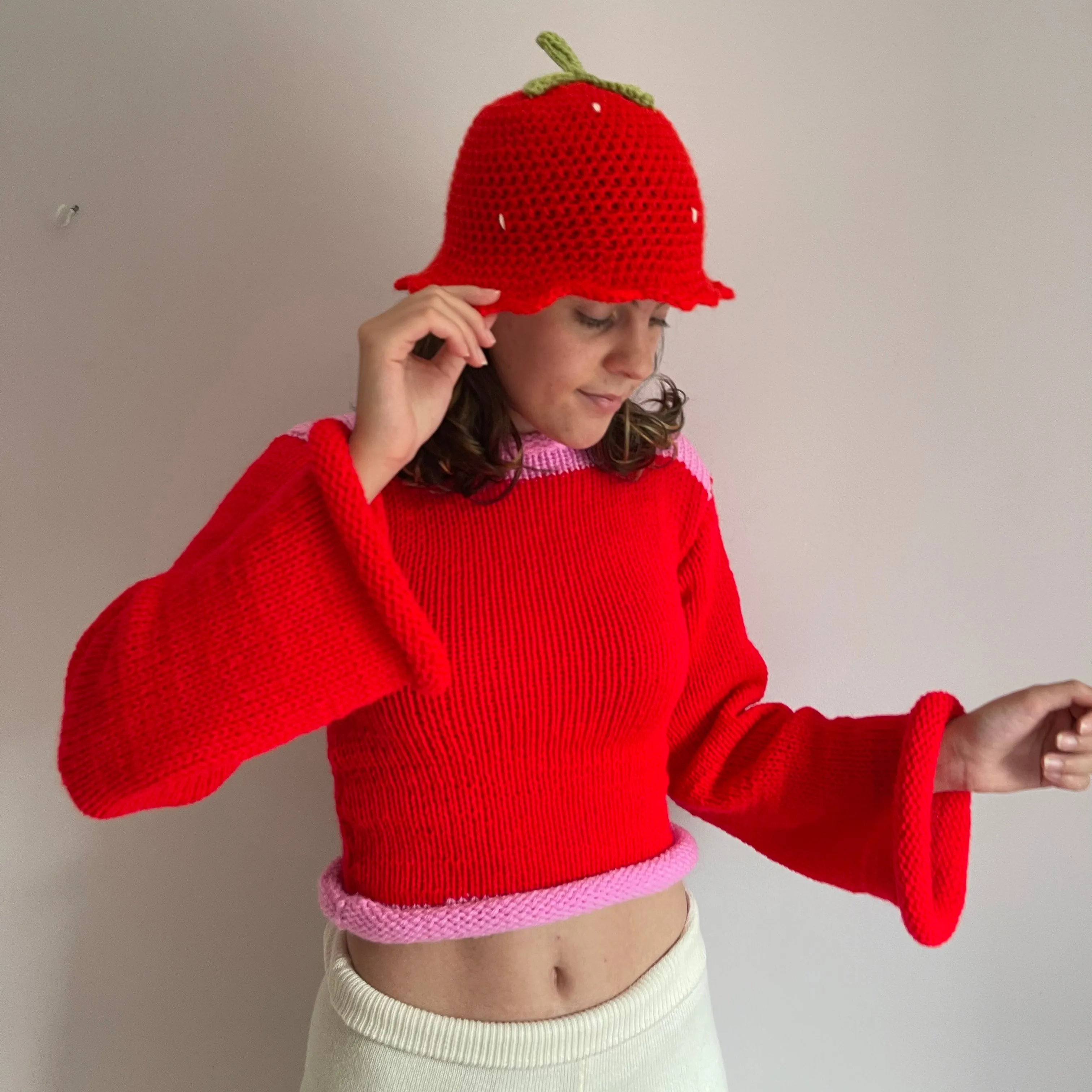 Handmade knitted colour block jumper in red and pink